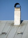 White chimney on the metal roof