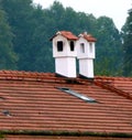 2 white chimneys plastered with brick cover on a tiled roof  3 Royalty Free Stock Photo