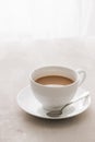 White china cup of tea with milk on a plain background Royalty Free Stock Photo