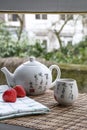 White Chinese teapot on the woven mat on the window