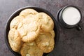 White Chocolate Caramel soft and macadamia nuts baked cookies served with cup of milk close-up. Horizontal top view Royalty Free Stock Photo