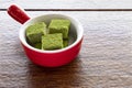 white chocolate fugde and green tea in a red dish Royalty Free Stock Photo