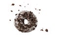 White chocolate glazed donut with dark cookies crumbs and creme filled closeup flying