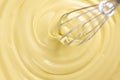 White chocolate. Melted liquid white chocolate mixing with a wisk. Closeup of molten liquid hot chocolate swirl Royalty Free Stock Photo