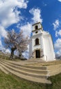 White christian chapel in Pecs with blooming almond tree