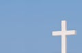 White Christian cross on blue sky Royalty Free Stock Photo