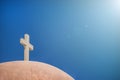 White Christian cross in front of a cloudy sky with copyspace Royalty Free Stock Photo