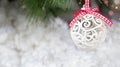 A white Christmas ball and a snow-covered tree branch on a snowy white background. Horizontal card banner place for text Royalty Free Stock Photo