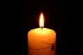 White christmas candle burning on a black background Royalty Free Stock Photo