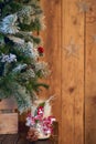 White Christmas candle holder decorated with pine cone and ashberry stick under Christmas tree on wooden background with stars Royalty Free Stock Photo