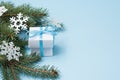 White christmas gift box on blue background,copy space. winter flat lay with green tree and snowflakes. greeting card Royalty Free Stock Photo