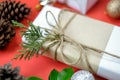 White Christmas gift box on red background decorated with green