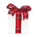 White Christmas gift box with red plaid pattern bow and ribbon isolated on white Royalty Free Stock Photo