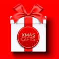 White Christmas gift box wrapped with red ribbon, and lettering label, lying on background. Royalty Free Stock Photo