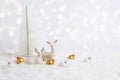 White Christmas greeting card. Two reindeer in snow on white background with golden baubles, Christmas tree and bokeh lights. Royalty Free Stock Photo