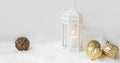 White Christmas lantern with white candle and golden balls on white soft faux fur Royalty Free Stock Photo