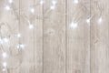 White Christmas lights corner border over light gray wood Royalty Free Stock Photo