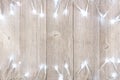 White Christmas lights double border over light gray wood Royalty Free Stock Photo