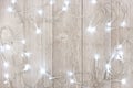 White Christmas lights frame over light gray wood