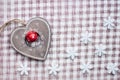 White christmas snowflakes and wooden heart decoration on checkered pink background. Vintage winter wallpaper. Top view Royalty Free Stock Photo