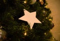 White christmas star decoration hanging on christmas tree Royalty Free Stock Photo