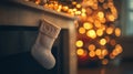 White Christmas Stocking Hanging on Fireplace Mantle with Blurred Lights in Background Royalty Free Stock Photo
