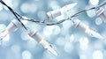 White Christmas string lights with clear bulbs on a twisted wire against a soft blue bokeh background Royalty Free Stock Photo