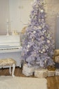 White Christmas tree decorated with silver and pink ornaments at the piano background.Winter scene. New Year decoration.Xmas Royalty Free Stock Photo