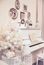 White Christmas tree with hand made ornaments and white piano. Winter time. New Year holiday. Royalty Free Stock Photo