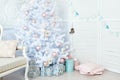 White Christmas tree with presents underneath in living room. Royalty Free Stock Photo