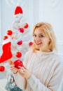 White christmas tree red balls. Woman christmas happy. Glamour celebration, christmas girl santa. Christmas tree white. Royalty Free Stock Photo