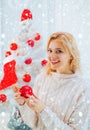 Woman in snow. White christmas tree red balls. Woman christmas happy. Glamour celebration, christmas girl santa Royalty Free Stock Photo