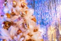 White christmas tree with yellow bauble and blue bokeh, copy space. Xmas decorations on new year Royalty Free Stock Photo