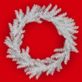 White Christmas wreath on red background. Christmas wreath of pine branches with silver frost