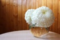 White chrysanthemum flowers in a glass transparent and round vase