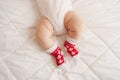 white chubby baby legs feet wearing red socks with Canadian maple leaf flag Royalty Free Stock Photo