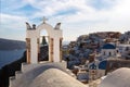 The white church bell tower on Santorini island in Greece, Oia village during sunset. Royalty Free Stock Photo