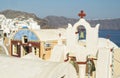 White Church with bells and blue dome at Oia, Santorini, Greek Islands Royalty Free Stock Photo