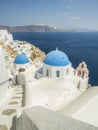 White Church with bells and blue dome at Oia, Santorini, Greek Islands Royalty Free Stock Photo