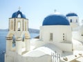 White Church with bells and blue dome at Oia, Santorini, Greek Islands Royalty Free Stock Photo