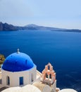 White church with blue dome against blue sea and sky background. Oia Santorini, Greece Royalty Free Stock Photo