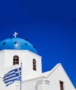 White church with blue dome against blue sky background. Santorini, Greece Royalty Free Stock Photo