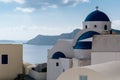 White church with blue dome in Oia village, Santorini, Greece. Royalty Free Stock Photo
