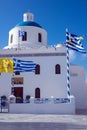 White Church with a blue dome in the village of Oia on the island of Santorini. Greek journey. Royalty Free Stock Photo