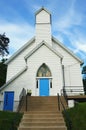 White Church With Blue Doors and Stained Glass