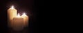 White church candles burning in the dark night background Royalty Free Stock Photo