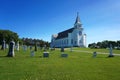 White church and cemetery under blue sky Royalty Free Stock Photo
