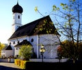 Typical south german church with onion tower and white facade under a blue sky
