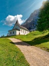 White church in the mountain. Sanctuary La Crusc translated Saint Cross in Alta Badia Dolomites