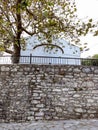 White church with old stone wall in Greek village Royalty Free Stock Photo